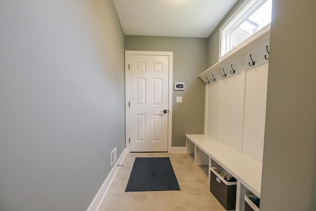 mudroom with baseboards and visible vents