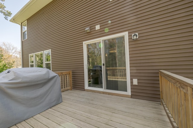 wooden deck featuring a grill