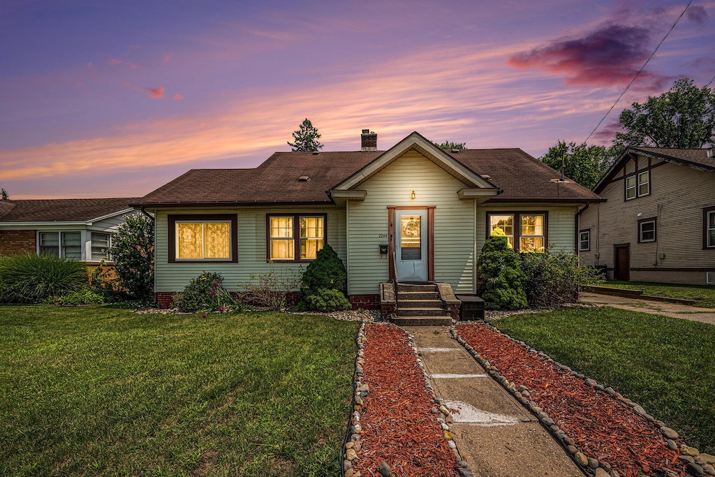 2244 Collingwood Ave SW, Wyoming, MI 49519 - bungalow with a yard, roof with shingles, and a chimney