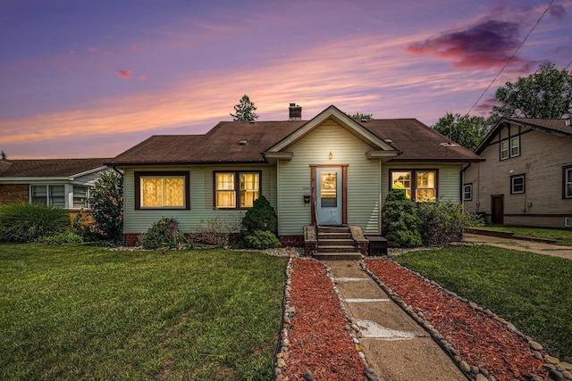2244 Collingwood Ave SW, Wyoming, MI 49519 - bungalow with a yard, roof with shingles, and a chimney