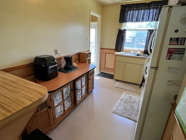 1452 E Madge Ave, Hazel Park, MI 48030 - kitchen with freestanding refrigerator, a wainscoted wall, and a sink