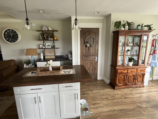 bar with pendant lighting, light wood-style flooring, baseboards, and recessed lighting