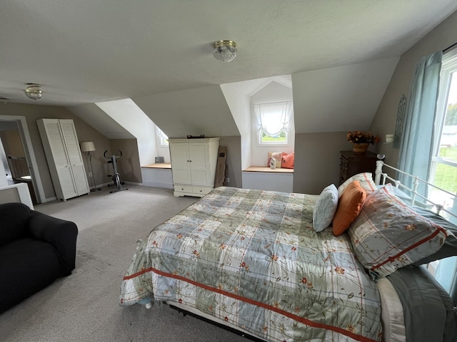 bedroom featuring baseboards, lofted ceiling, and carpet floors