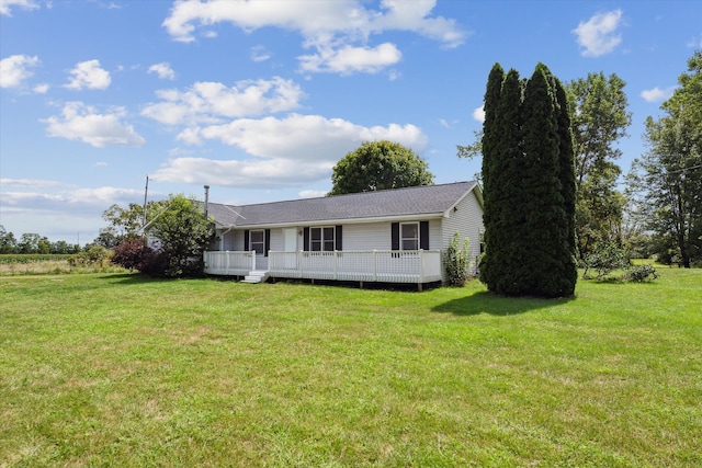 view of front of house with a deck and a front lawn