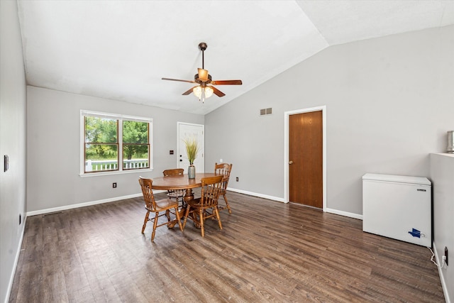 dining area with wood finished floors, visible vents, vaulted ceiling, ceiling fan, and baseboards