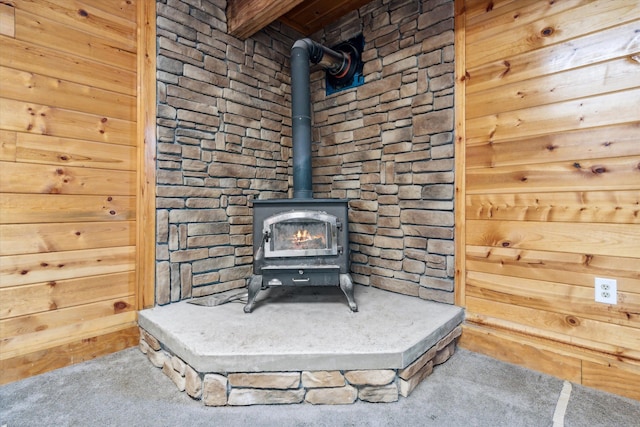details with a wood stove and carpet