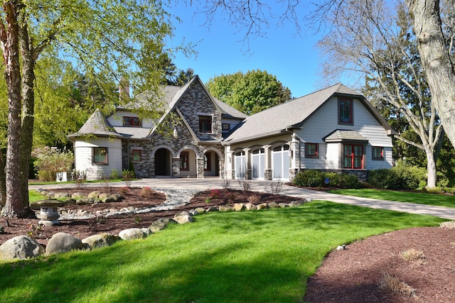 1256 Lenhill Ct, Bloomfield Hills, MI 48304 - view of front facade featuring stone siding, a front yard, and curved driveway