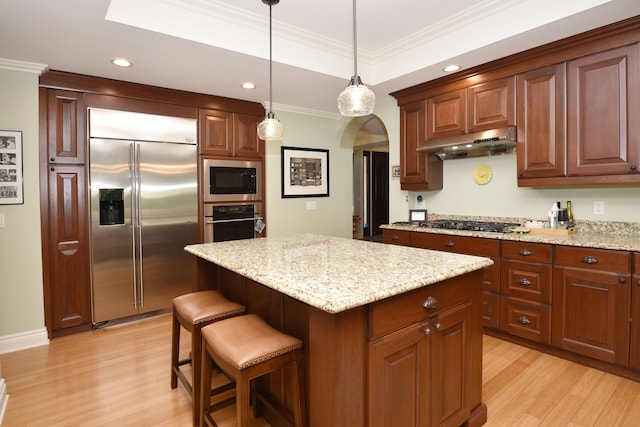 1256 Lenhill Ct, Bloomfield Hills, MI 48304 - kitchen featuring built in appliances, under cabinet range hood, light wood-type flooring, arched walkways, and ornamental molding