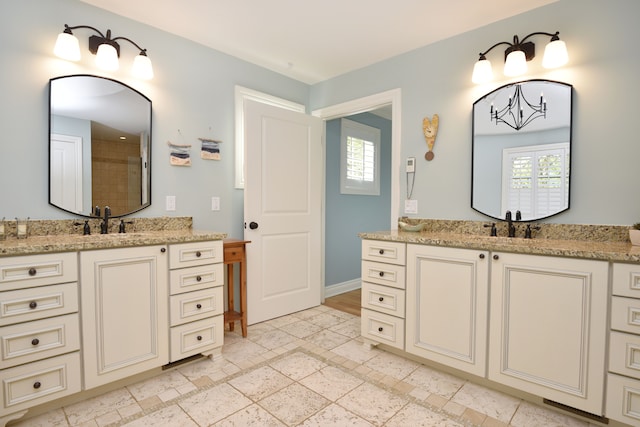 1256 Lenhill Ct, Bloomfield Hills, MI 48304 - bathroom featuring two vanities, a tile shower, baseboards, and inlaid floor details