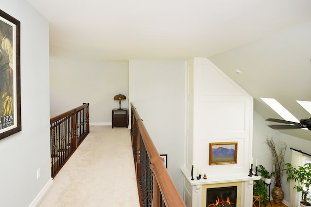 1256 Lenhill Ct, Bloomfield Hills, MI 48304 - corridor featuring an upstairs landing, a skylight, light colored carpet, and baseboards