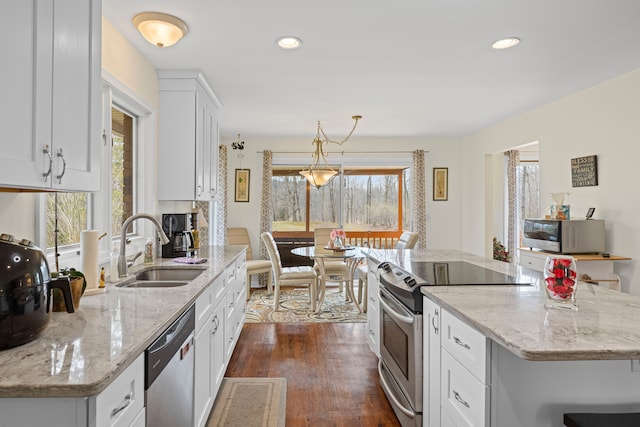 kitchen with white cabinetry, a healthy amount of sunlight, appliances with stainless steel finishes, and a sink