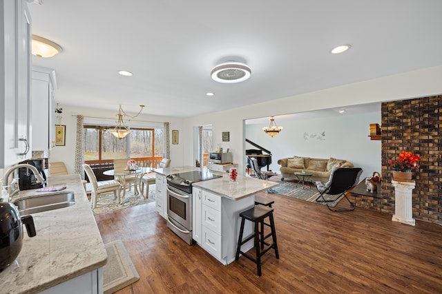 kitchen featuring white cabinets, appliances with stainless steel finishes, a sink, and dark wood-type flooring