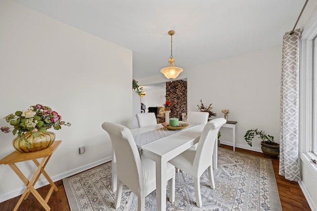 dining area featuring baseboards and wood finished floors