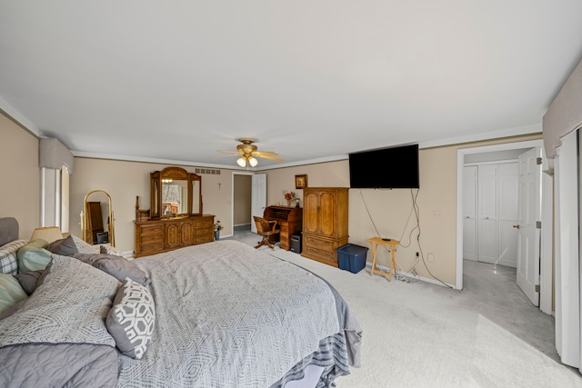 carpeted bedroom featuring ornamental molding, visible vents, baseboards, and ceiling fan