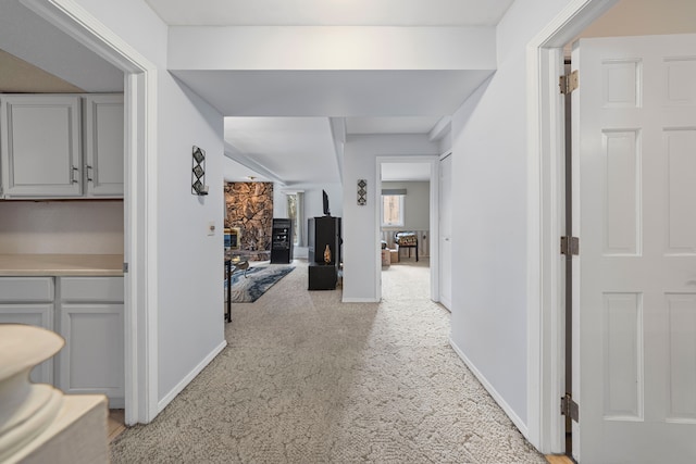 hall with light carpet and baseboards