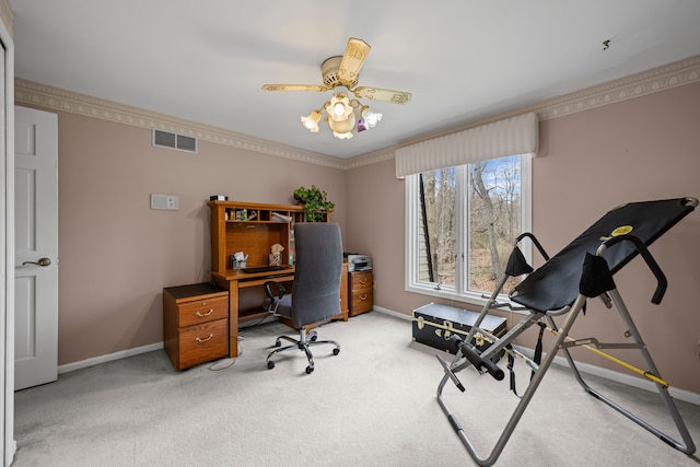 office space with baseboards, ceiling fan, light carpet, and visible vents
