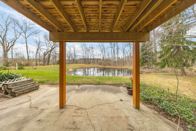 view of patio with a water view