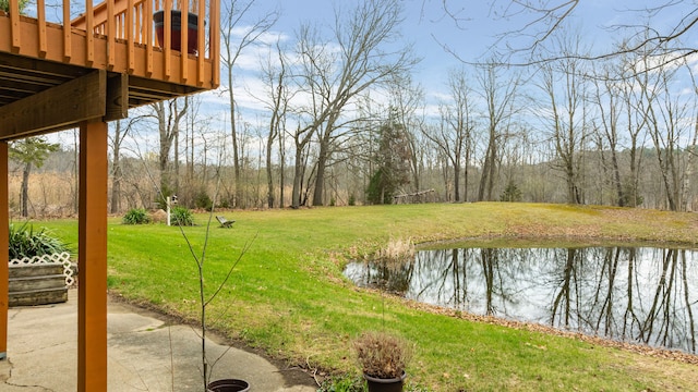 view of yard with a patio area and a deck with water view