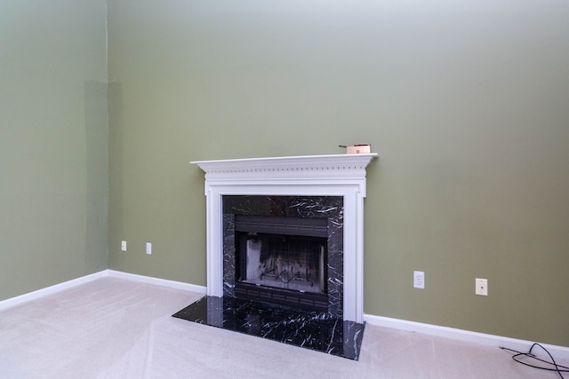 detailed view of carpet flooring, a fireplace, and baseboards