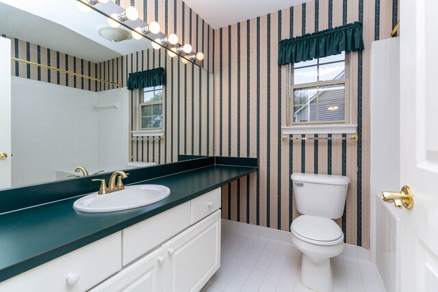 bathroom featuring healthy amount of natural light, tile patterned flooring, toilet, wallpapered walls, and vanity