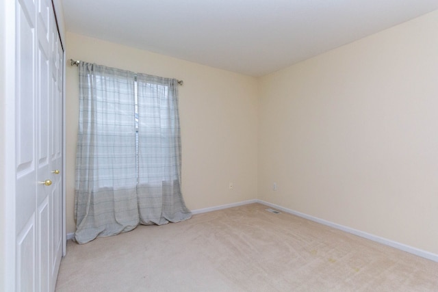 carpeted empty room with baseboards