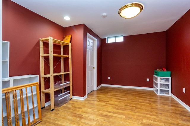 spare room featuring wood finished floors and baseboards