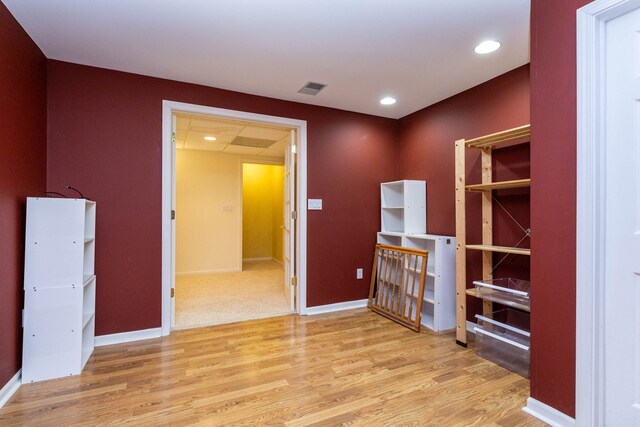 spare room featuring wood finished floors, baseboards, and recessed lighting