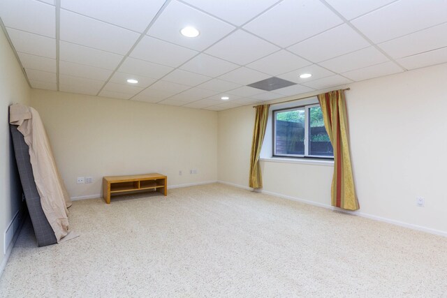 carpeted empty room with a paneled ceiling, recessed lighting, and baseboards