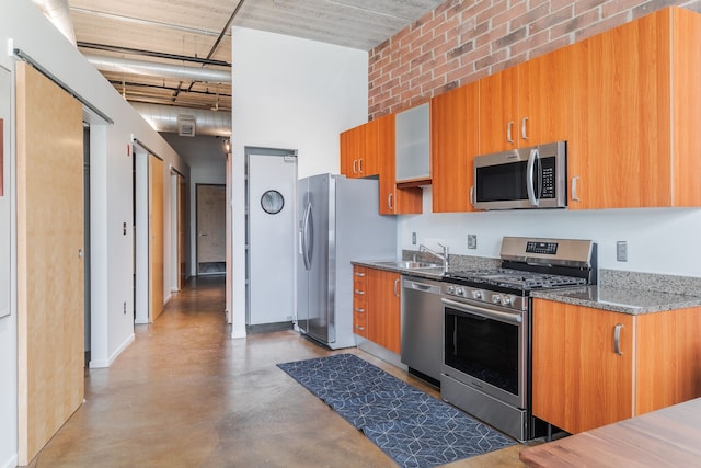 kitchen with a sink, brown cabinetry, and appliances with stainless steel finishes