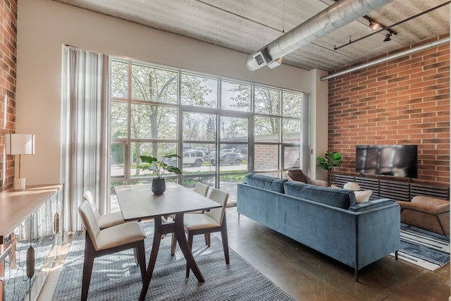 living area with finished concrete flooring and a high ceiling