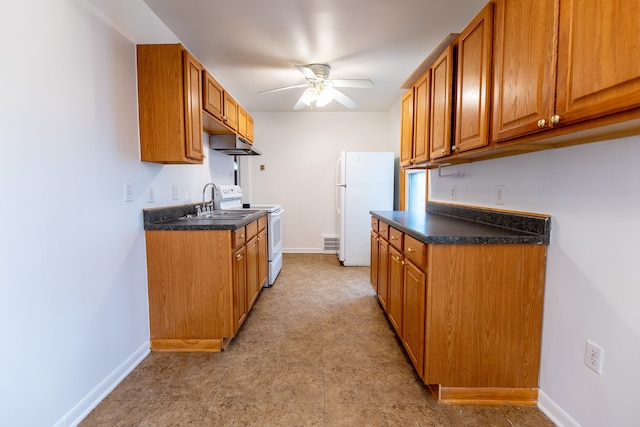 kitchen with ceiling fan, white appliances, baseboards, and dark countertops