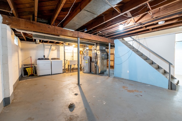 unfinished below grade area featuring gas water heater, stairs, heating unit, washing machine and dryer, and concrete block wall