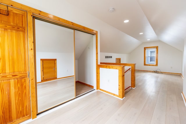 bonus room featuring lofted ceiling, recessed lighting, light wood-type flooring, and visible vents