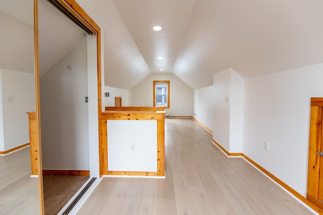additional living space featuring lofted ceiling, light wood-style floors, recessed lighting, and baseboards