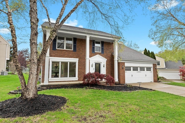 greek revival inspired property featuring concrete driveway, brick siding, an attached garage, a front yard, and central AC unit
