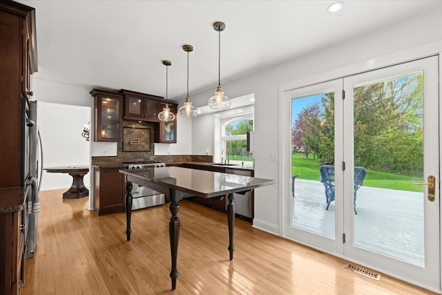 dining space with light wood finished floors, recessed lighting, and baseboards