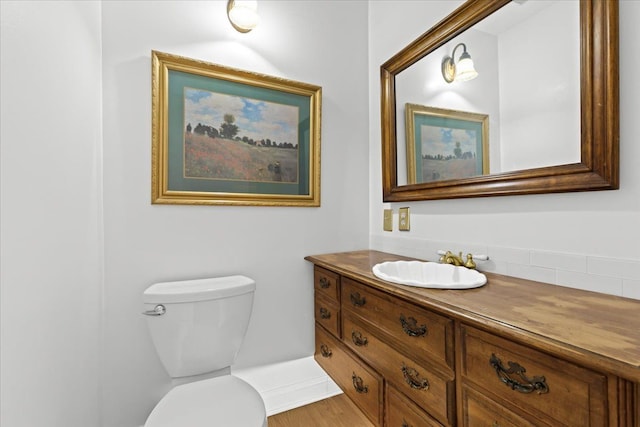 half bathroom with toilet and vanity