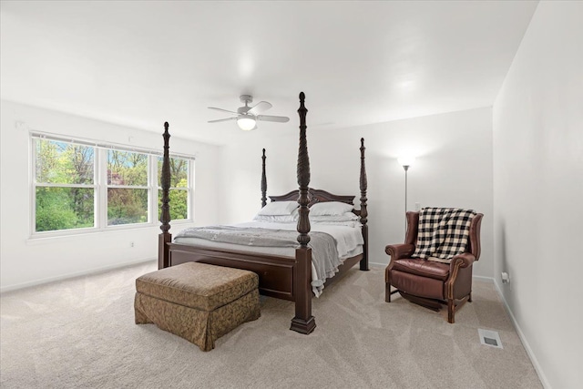 bedroom with light carpet, baseboards, and a ceiling fan