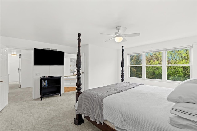 bedroom featuring light carpet and a ceiling fan