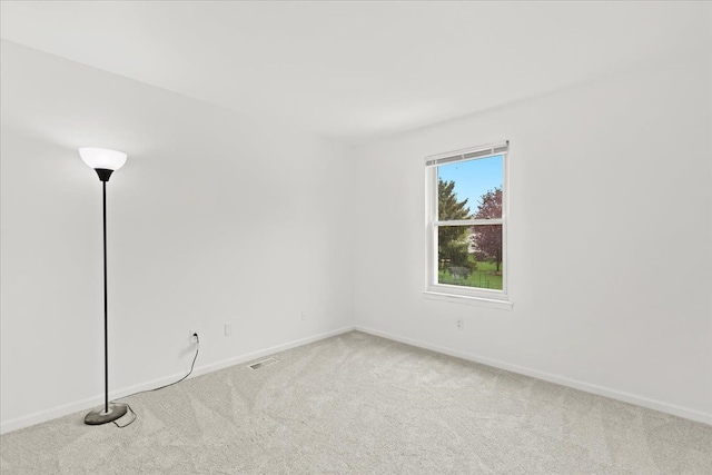 carpeted spare room with baseboards