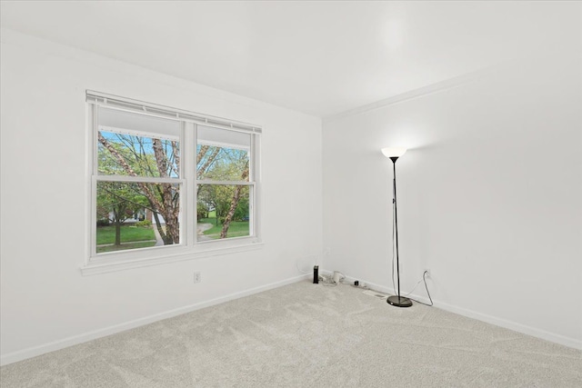 carpeted empty room with baseboards