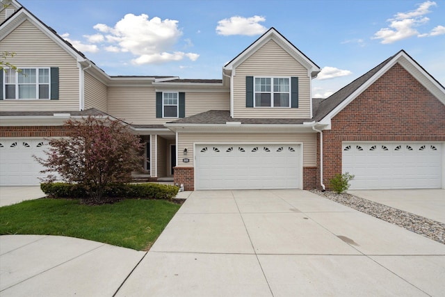 view of front facade featuring brick siding and driveway