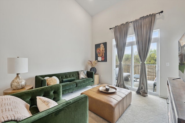 living room featuring high vaulted ceiling and light colored carpet