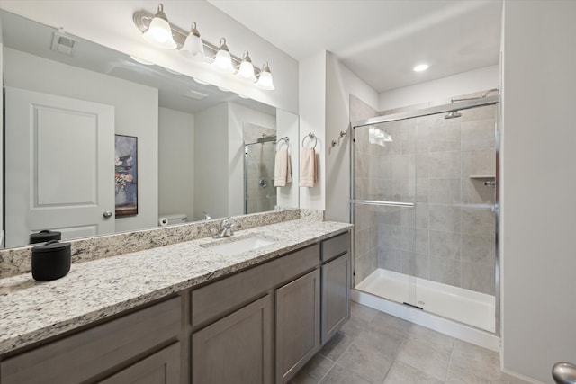 bathroom with a stall shower, tile patterned flooring, vanity, and toilet