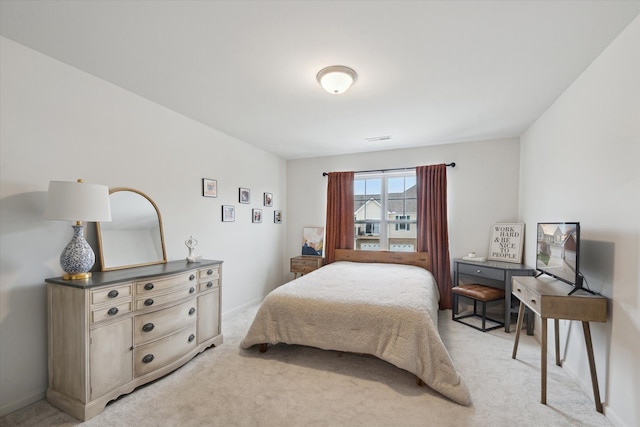 bedroom featuring light colored carpet and baseboards