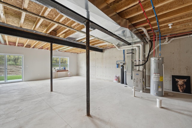basement featuring electric water heater and heating unit