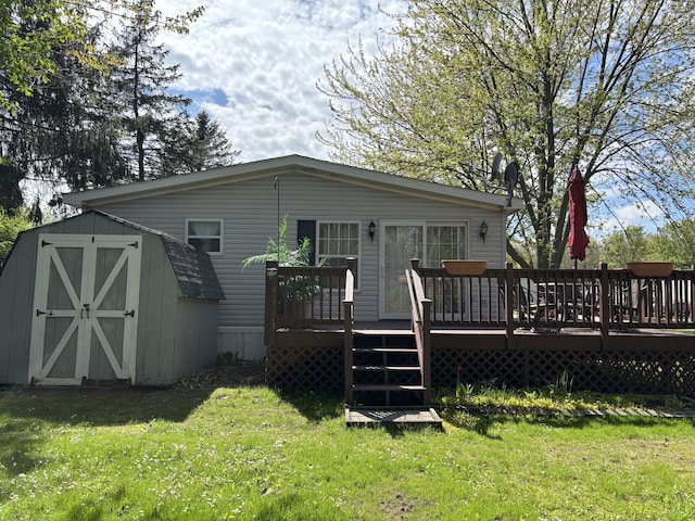 back of property featuring a storage shed, a lawn, an outbuilding, and a wooden deck
