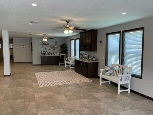 kitchen featuring ceiling fan, dark brown cabinets, recessed lighting, light countertops, and baseboards
