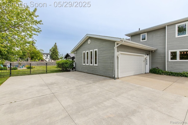 61 Cutting Dr, Troy, MI 48085 - view of side of home featuring concrete driveway and an attached garage