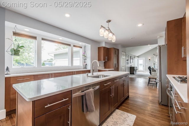 61 Cutting Dr, Troy, MI 48085 - kitchen featuring stainless steel appliances, a sink, light countertops, open floor plan, and wood finished floors